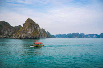 Obraz na płótnie Canvas Halong Bay, Vietnam, with limestone hills. Dramatic landscape of Ha Long bay, a UNESCO world heritage site and a popular tourist destination.