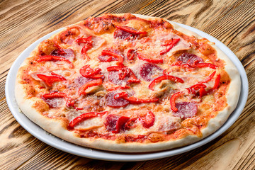 Italian pizza on a thin dough with a variety of stuffed. Mixed media