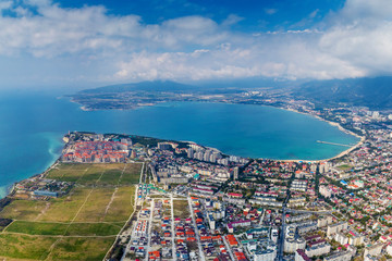 Panorama of Gelendzhik and Gelendzhik Bay from a bird's-eye view. In the foreground is a "Thick" Cape with a lighthouse and residential complexes. Beyond it is the Bay 