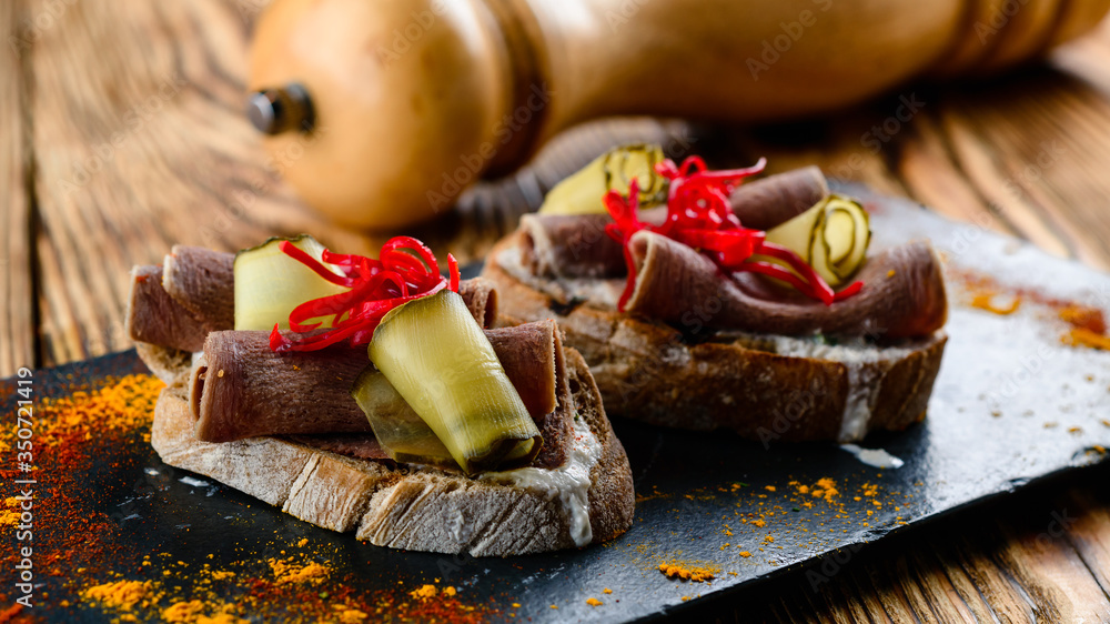 Wall mural set of different bruschetta with tongue and cucumber