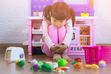 Sad little girl sitting on floor with toy,children crying, little girl cry, feeling sad, young girl unhappy.