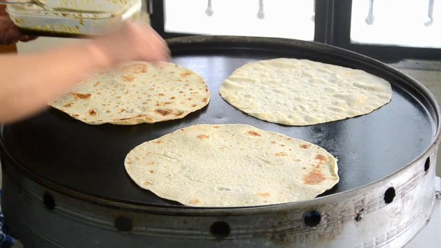 Lebanese food: Manakish. A cook who prepares a man'ousheh (manoushe, manakeesh) A type of pizza covered with olive oil mixed with the traditional Zaatar seasoning.
