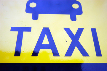 Yellow Taxi sign with pictogram of a car
