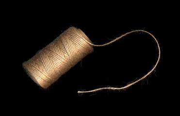 Natural rope, hemp cord isolated on black background