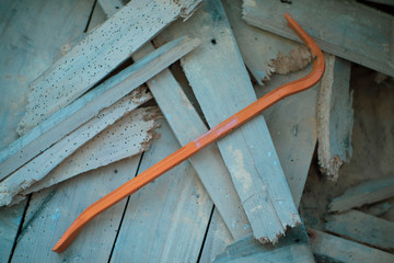 Crowbar on demolished wood eaten by woodworm