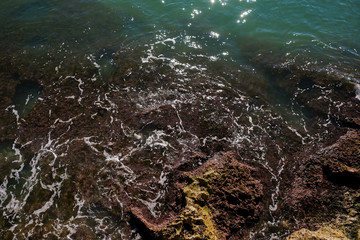 Obraz premium Aerial view of rocky coast on a sunny day