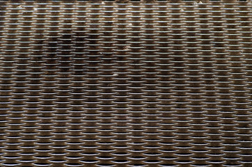 Obraz premium The surface of the metal step from the metal grate, top view.