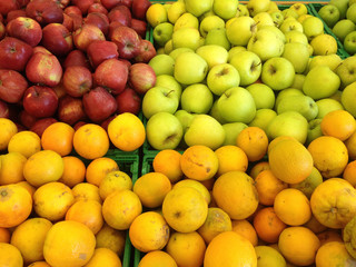 Apples and oranges fruits in a supermarket, food and retail concept