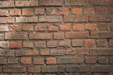 Weathered texture of stained old dark brown and red brick wall background, grungy rusty blocks of stone-work technology, colorful horizontal architecture