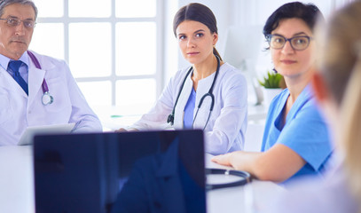 Serious medical team discussing patient's case in a bright office