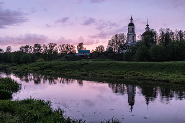 Orthodox Church by the river in the evening sunset
