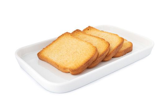 Horizontal crispy biscottes, square cracker on white plate, on white background (Tr- etimek)