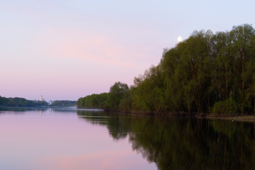 Naklejka na ściany i meble Summer landscape. Willows reflected in the water of the river and the Orthodox monastery in the distance on the horizon and the moon in the sky