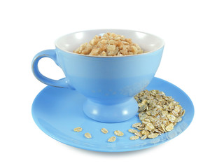 Oatmeal in blue bowl on plate with sprinkled dry oat flakes isolated on white background       