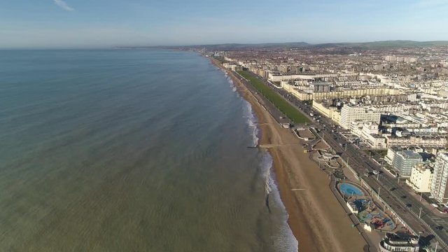 Brighton beach west of i360 from high aerial perspective with calm seas and low winter sun