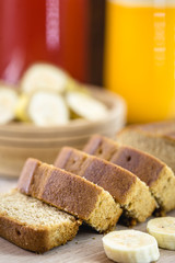 Gluten-free vegan bread and no animal products. Vegetarian bread, with banana slices in the background and glasses of juices in the background. Vibrant colors.