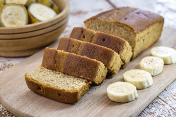 Gluten-free vegan bread and no animal products. Vegetarian bread with oatmeal, banana flavor, on a rustic white table, sliced ​​and ready to serve.
