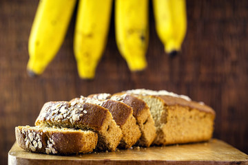 Sliced ​​vegan bread, gluten-free and without animal products. Vegetarian bread with oatmeal, banana flavor, on a rustic white table, sliced ​​and ready to serve.