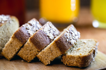 Sliced ​​vegan bread, gluten-free and without animal products. Vegetarian bread with oatmeal, banana flavor, on a rustic white table, sliced ​​and ready to serve.