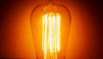 Edison light bulb glowing in the dark