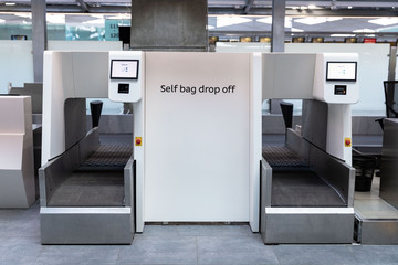 Luggage drop off service in airport terminal. Self bag drop kiosks.