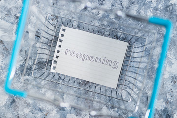 reopening businesses after lockdown, empty shopping basket with Reopning memo in it