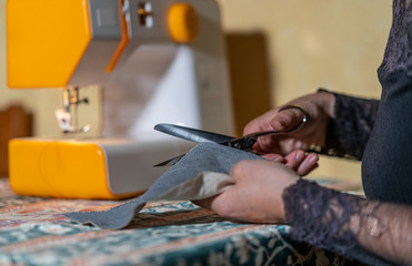 woman making and cutting for machine sewing garments