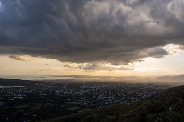 wide angle shot of an ominous set of clouds looming over a city at sunset one spring afternoon 