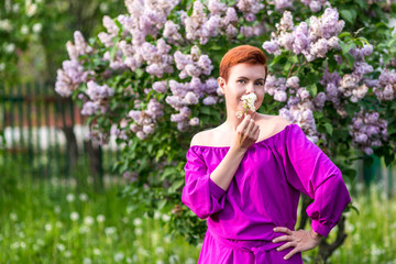 Fashion portrait of young beautiful pretty girl posing against greenery