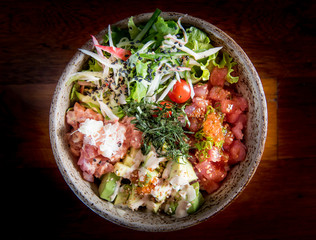 Salmon poke with avocado, seaweed, pickled carrots and cucumber
