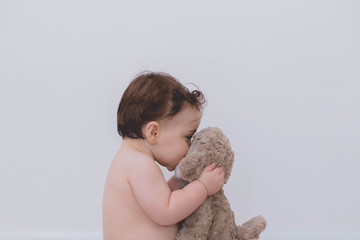 little boy with his teddy kissing 