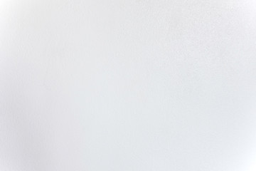 The surface of the house wall is made of concrete, smooth and white painted.