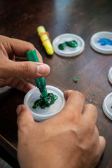 Colorful sparkle glitter glue. Arts and crafts on wooden background