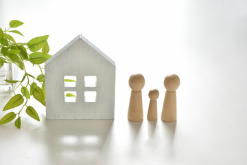Wooden figures with white house