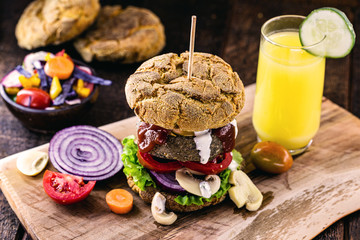 vegan snack, meatless hamburger, vegetarian food based on plants and proteins, with organic ketchup and white herbal sauce. Healthy food.