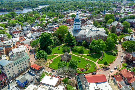 Aerial view of Maryland State House capitol building white dome and state circle with colonial houses in  Annapolis on a sunny weekend afternoon 