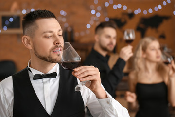 Sommelier tasting wine at the restaurant