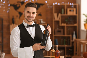 Waiter with bottle of wine at the restaurant
