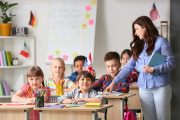 Teacher conducting lesson for little children at language school