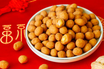 Peanut snack in a plate red background close up