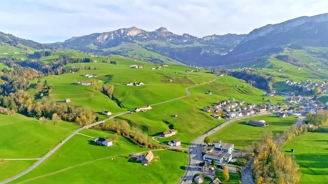 Aerial view of charming Swiss town, green mountians and houses