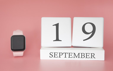 Modern Watch with cube calendar and date 19 september on pink background. Concept autumn time vacation.