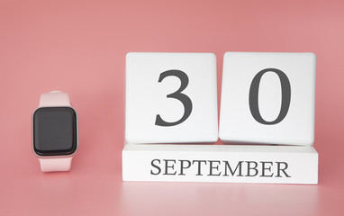 Modern Watch with cube calendar and date 30 september on pink background. Concept autumn time vacation.