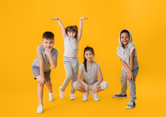 Cute little dancers on color background