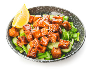 Bowl with tasty tofu cheese and vegetables on white background