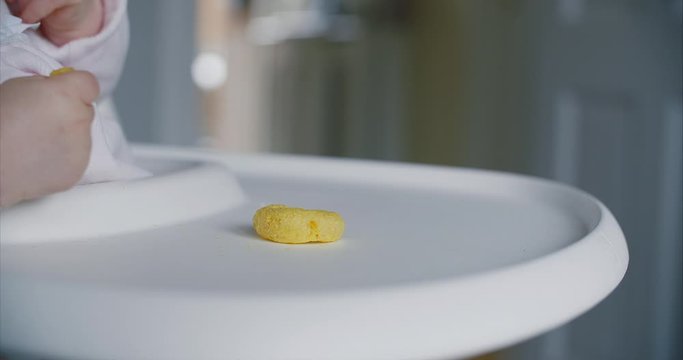 Close Up Of A Baby Girl Eating Crisps