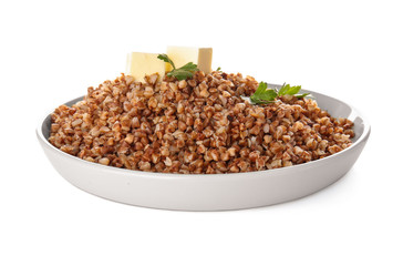 Plate with tasty buckwheat porridge on white background