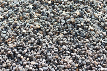 Texture of a small stone. Grey small stones