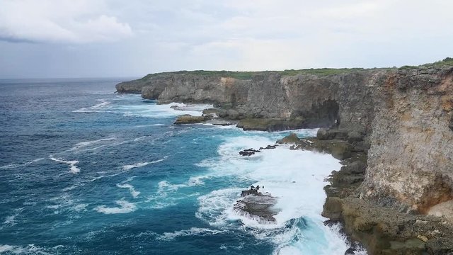 Rough waves hit stony rocks in Guadeloupe slow motion