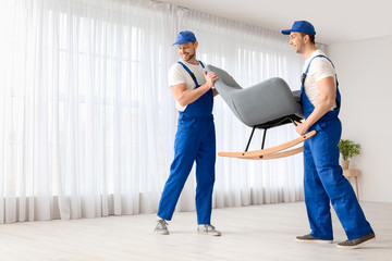 Loaders carrying furniture in flat